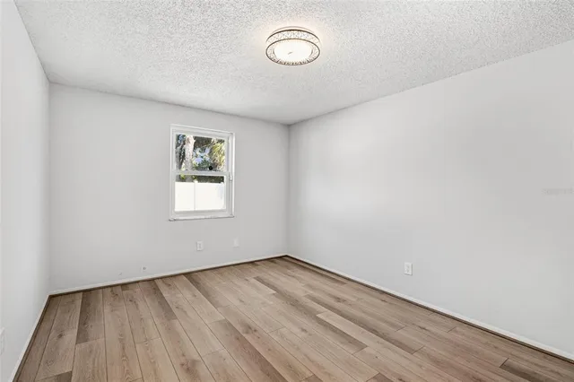 a view of room with wooden floor and window