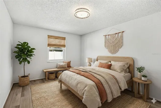 a bedroom with a bed and a potted plant