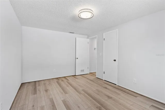 a view of room with wooden floor