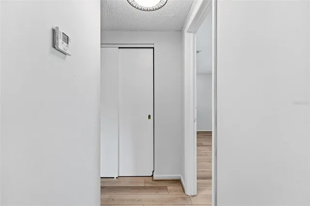 a view of a hallway with wooden floor