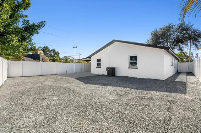 a view of a white house with a yard