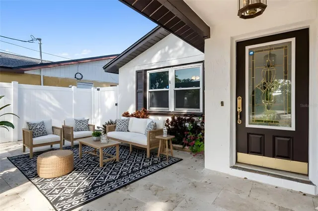 a outdoor space with patio the couches and a dining table with the view of the house