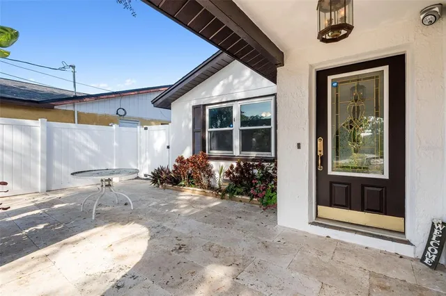 a backyard of a house with yard and outdoor seating