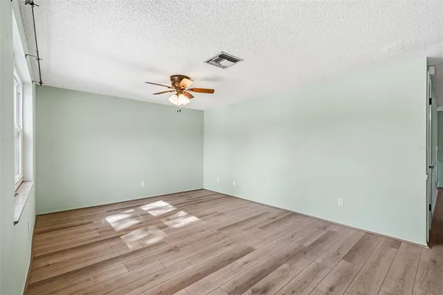 a view of a room with wooden floor