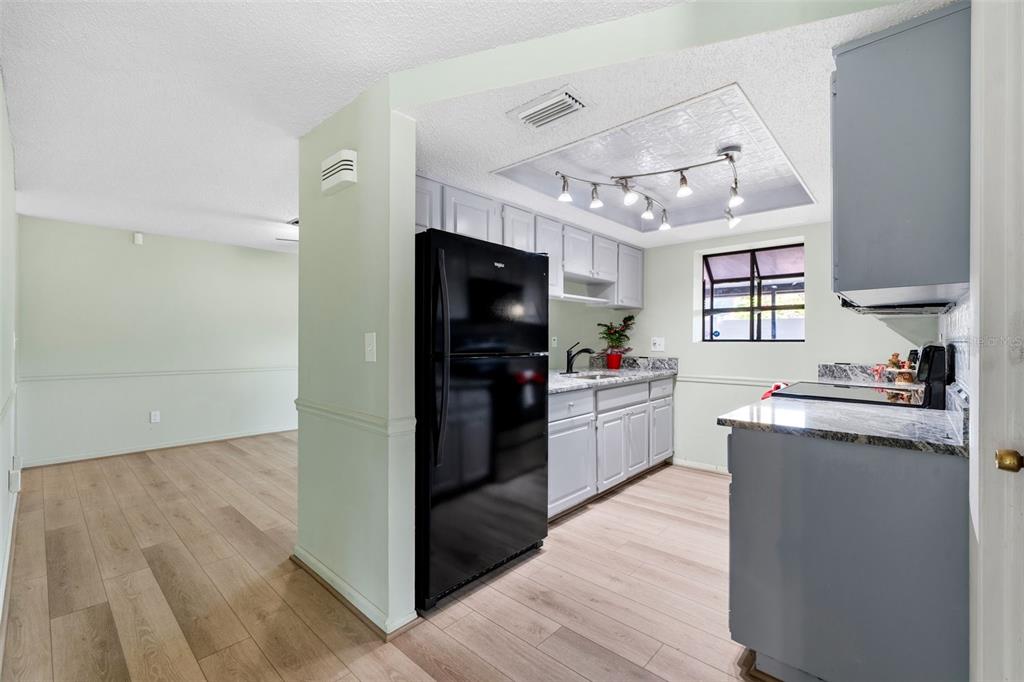 10187 122nd Avenue Largo, FL 33773 - Photo 10 of 48 a kitchen with granite countertop a refrigerator stove top oven and sink