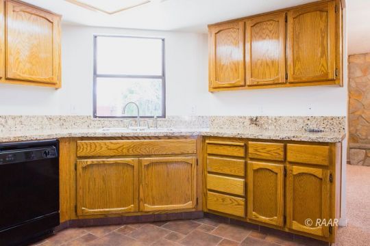 1114 North Inyo Street Ridgecrest, CA 93555 - Photo 12 of 31 a kitchen with stainless steel appliances granite countertop cabinets and window