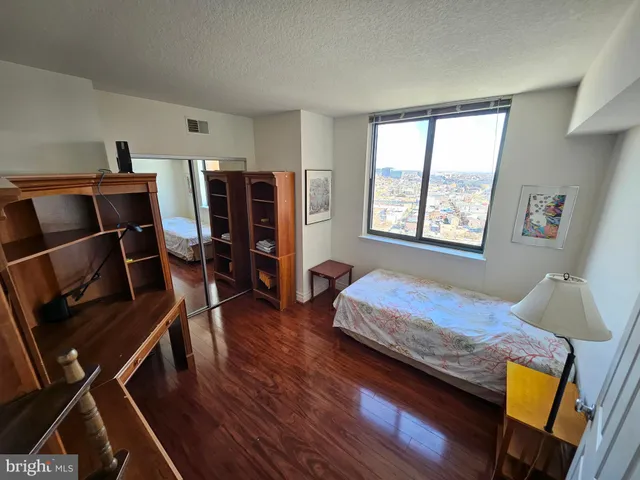 a bedroom with furniture and a window