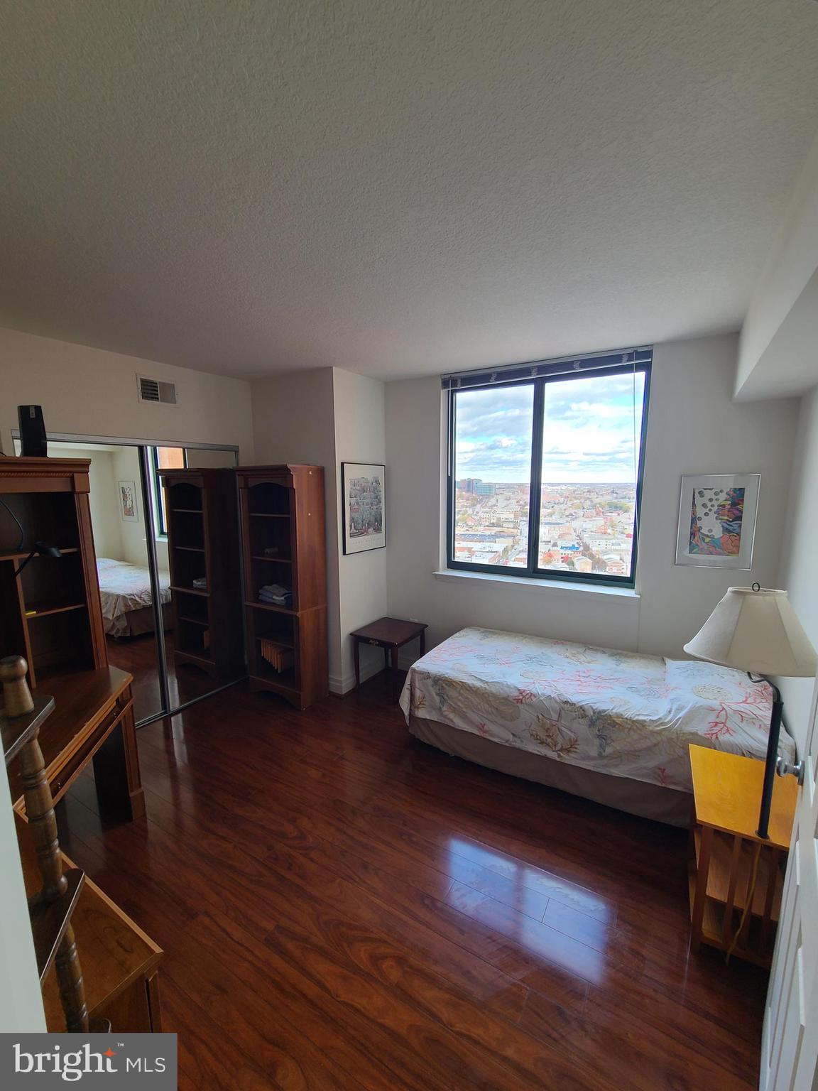 414 Water Street, Unit 2613 Baltimore, MD 21202 - Photo 13 of 42 a bedroom with a bed and wooden floor