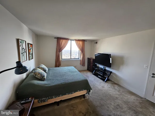 a bedroom with a bed and window