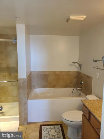 a bathroom with a toilet a sink and bathtub