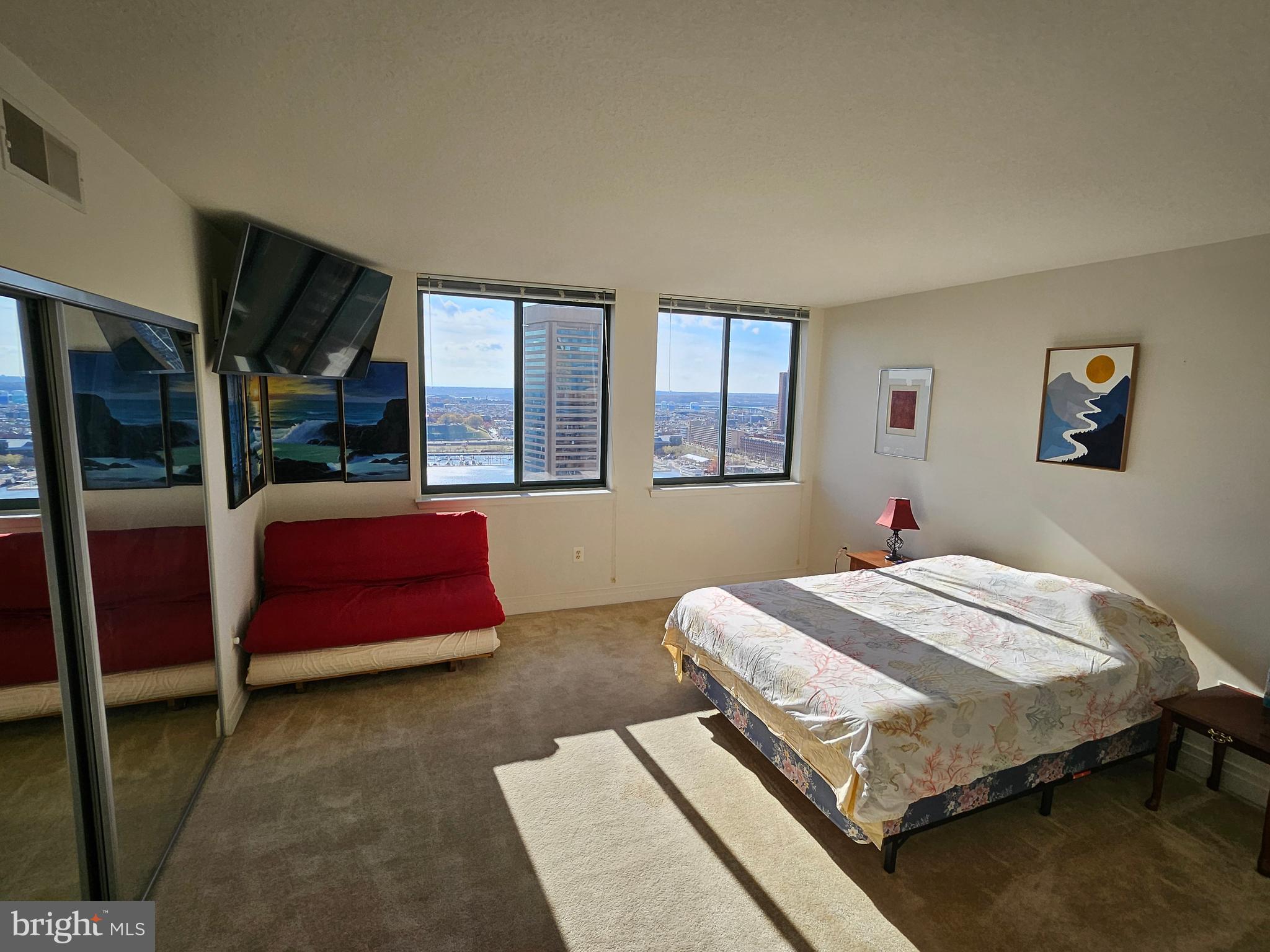 414 Water Street, Unit 2613 Baltimore, MD 21202 - Photo 25 of 42 a bedroom with a bed wooden floor and window