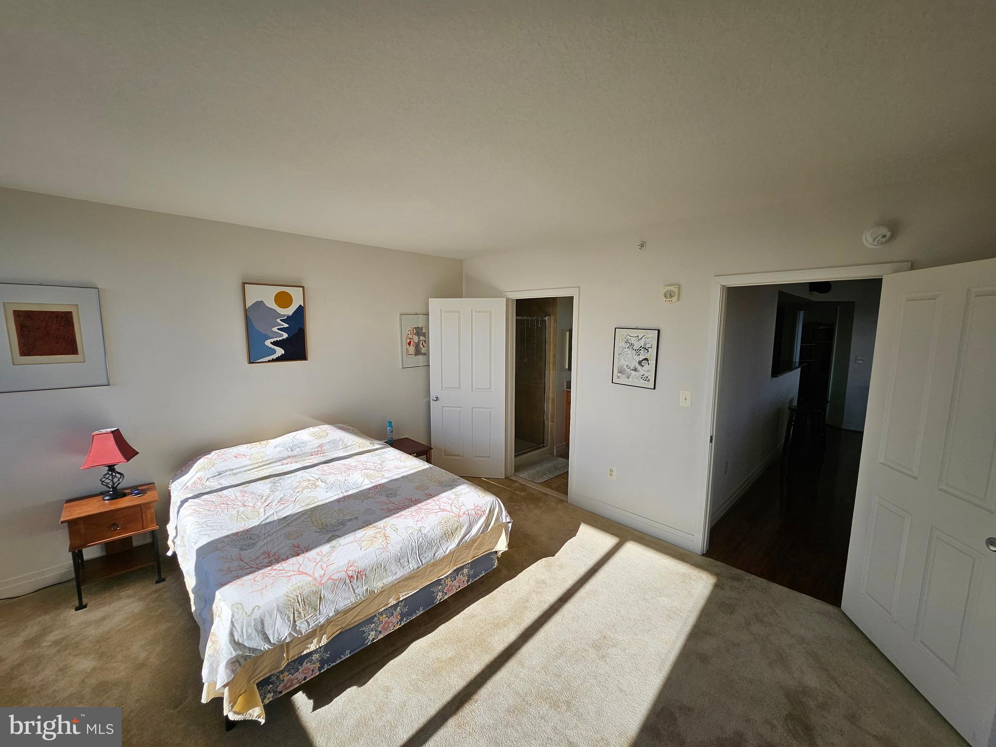 414 Water Street, Unit 2613 Baltimore, MD 21202 - Photo 29 of 42 a bedroom with a bed and wooden floor