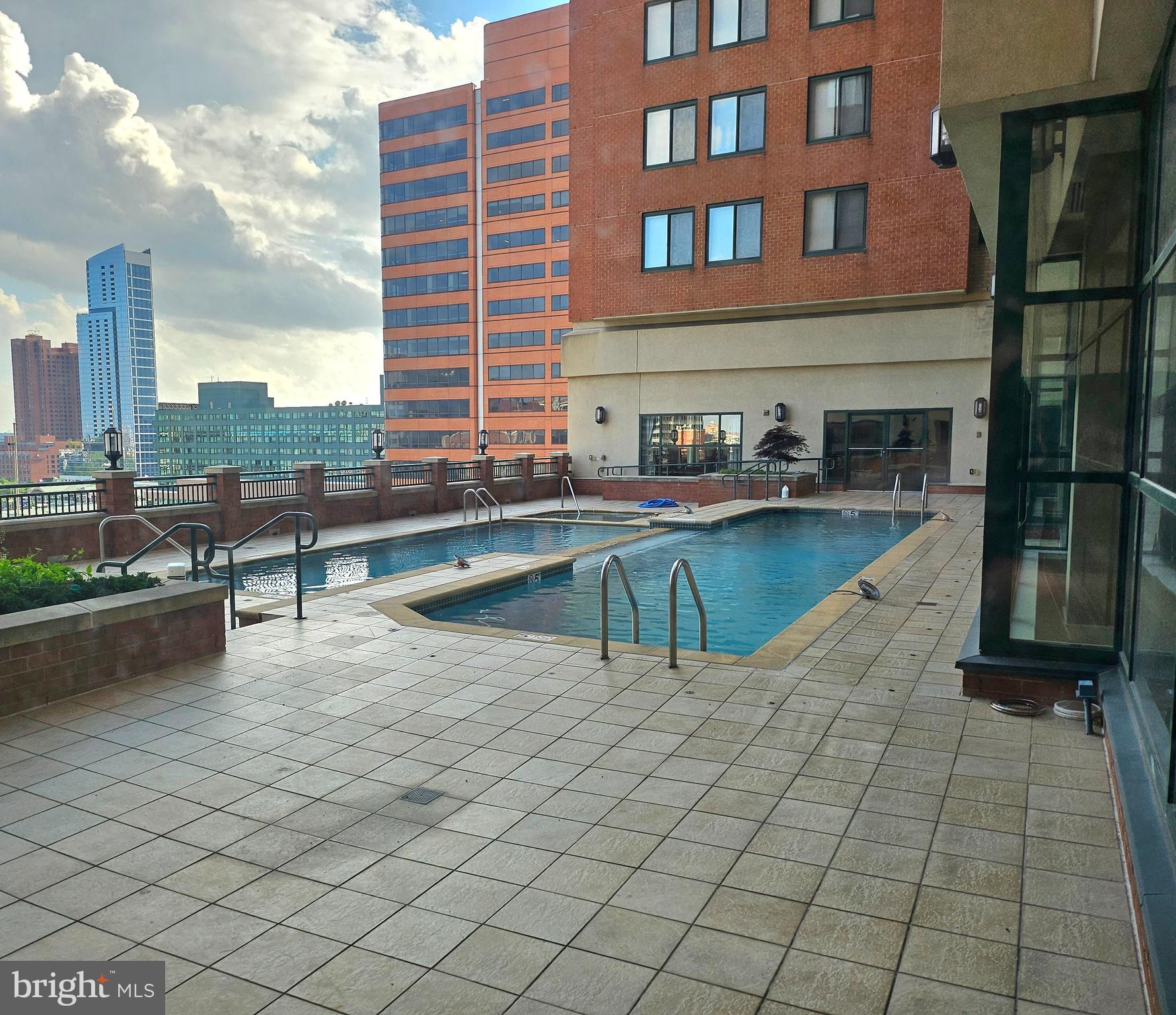 414 Water Street, Unit 2613 Baltimore, MD 21202 - Photo 40 of 42 a view of a swimming pool with a lounge chairs