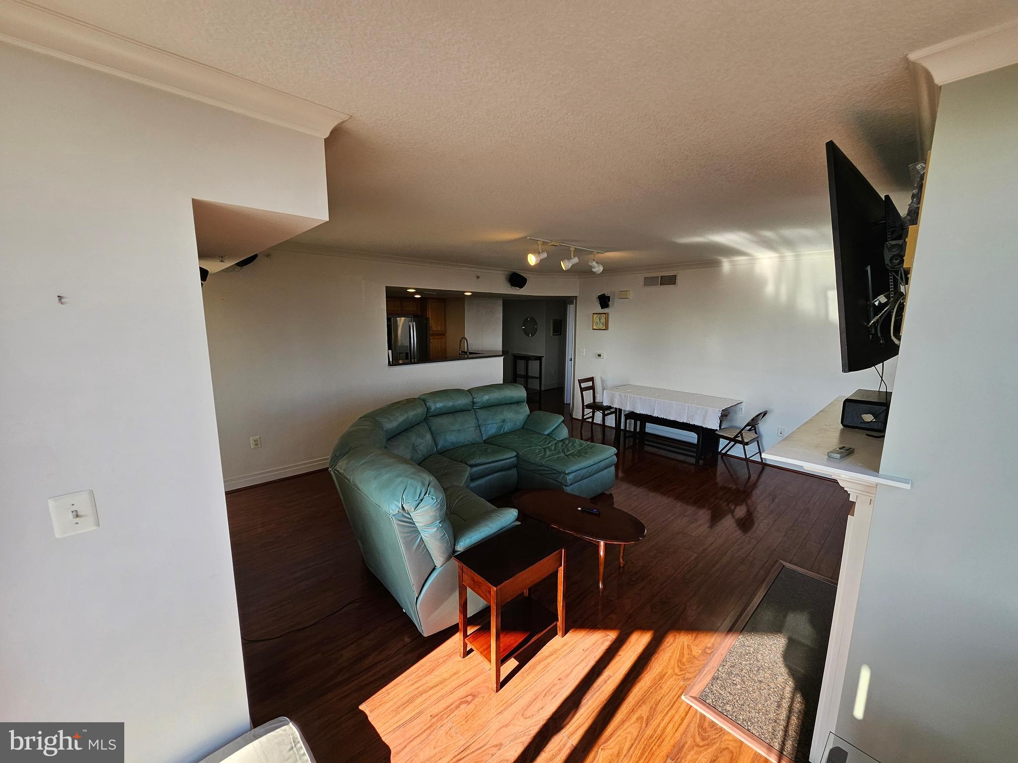 414 Water Street, Unit 2613 Baltimore, MD 21202 - Photo 4 of 42 a living room with furniture and a flat screen tv