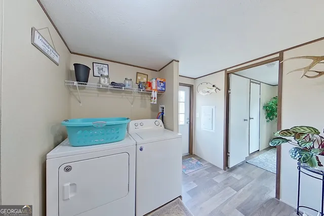 a utility room with cabinets washer and dryer
