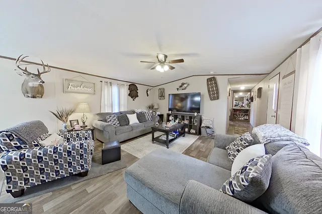 a living room with furniture and a chandelier
