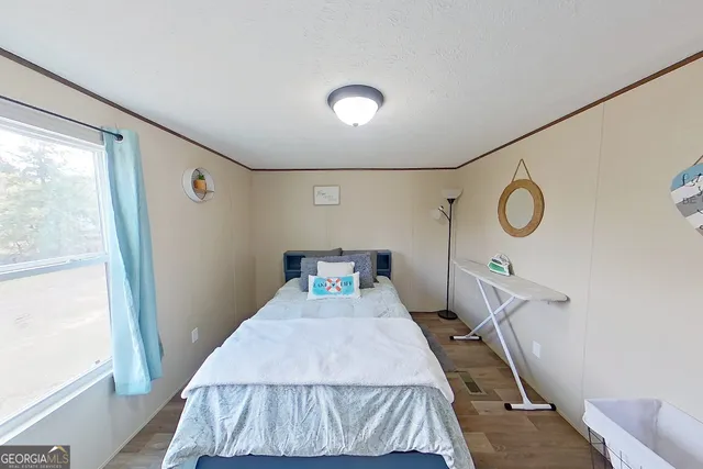 a bed room with a bed and a window