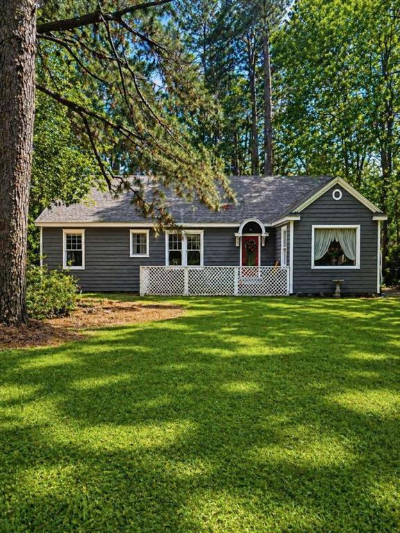 a front view of house with yard and green space