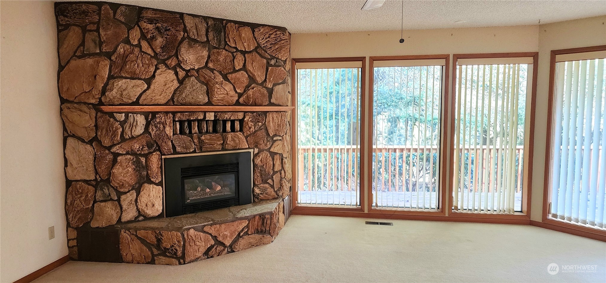 1230 Devries Road Oak Harbor, WA 98277 - Photo 14 of 39 a living room with furniture a fireplace and a window