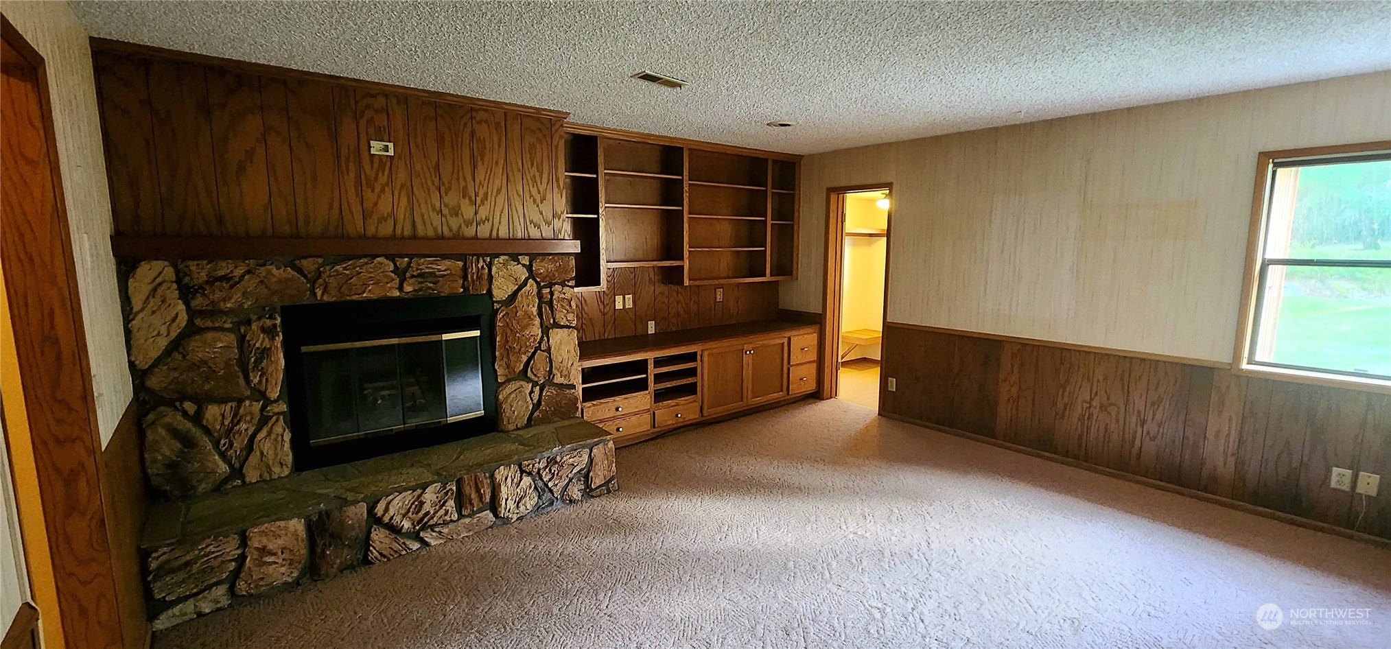 1230 Devries Road Oak Harbor, WA 98277 - Photo 17 of 39 a view of an empty room with fire place and a window