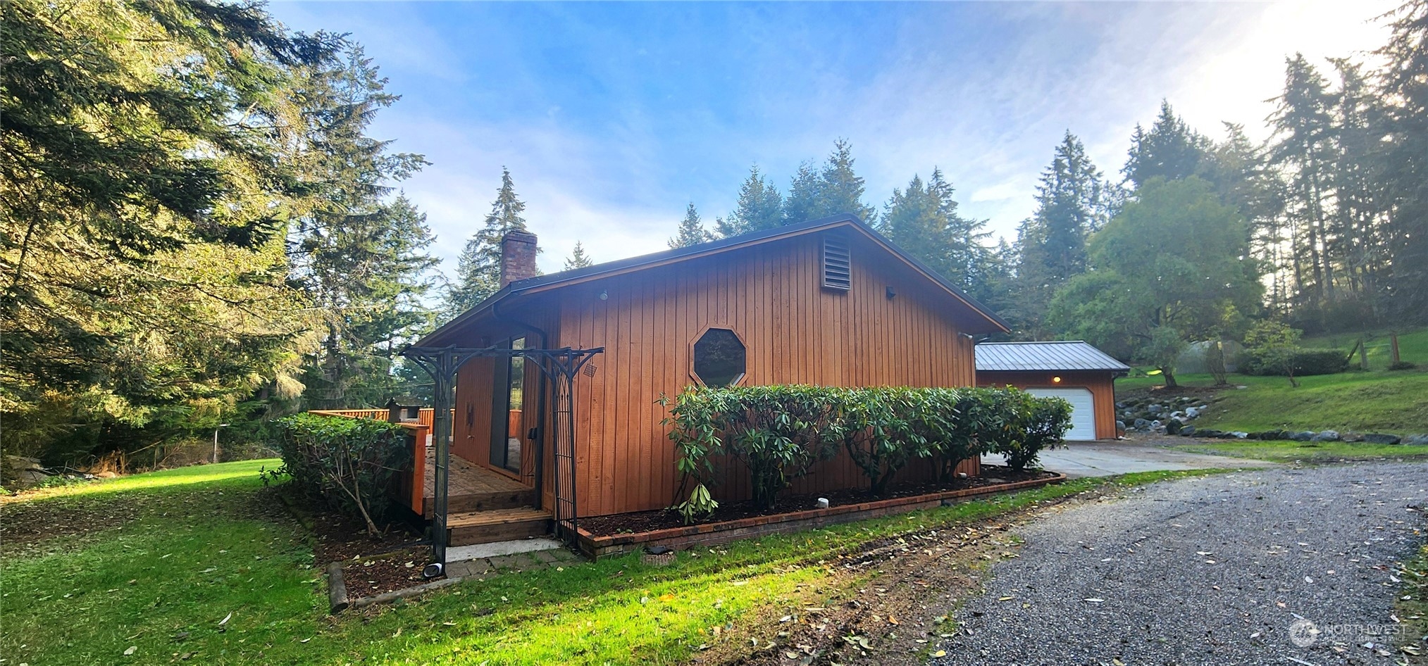 1230 Devries Road Oak Harbor, WA 98277 - Photo 38 of 39 a view of backyard with potted plants and a large tree