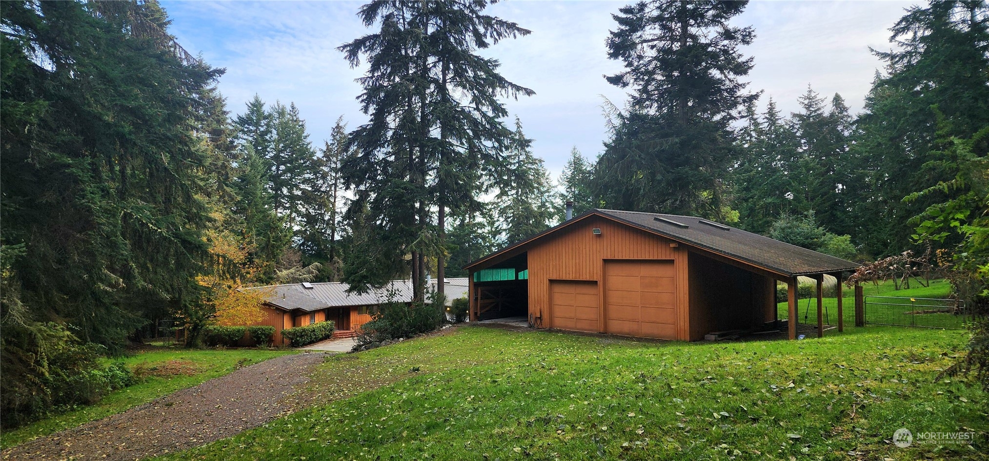 1230 Devries Road Oak Harbor, WA 98277 - Photo 4 of 39 a backyard of a house with wooden deck and trees