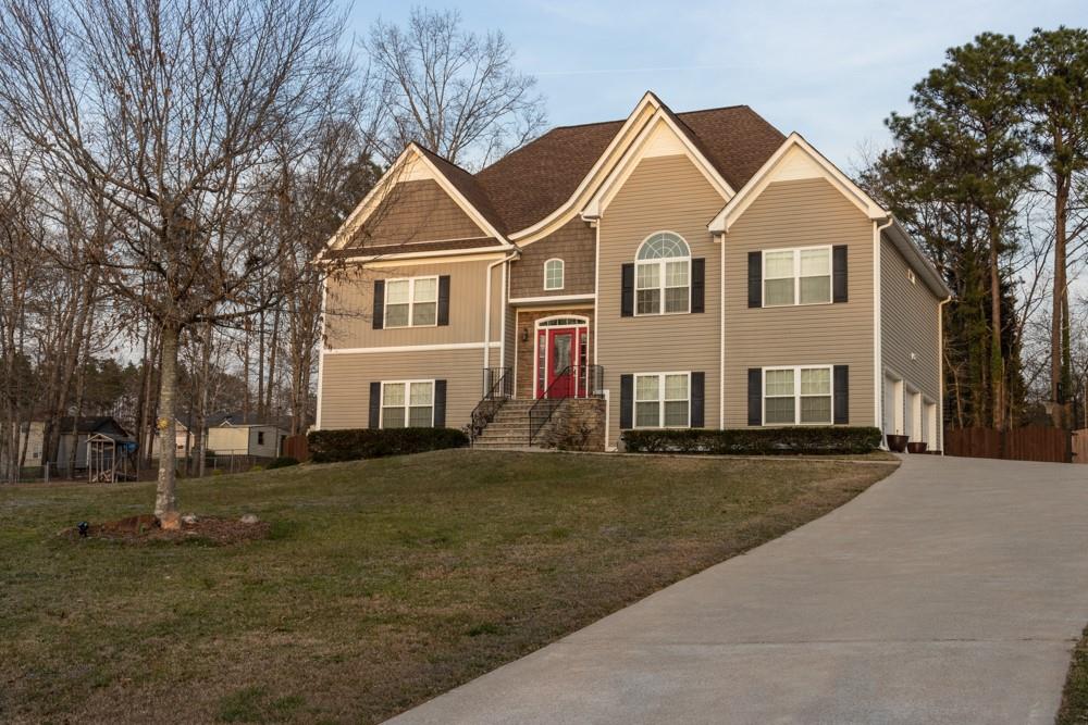 8842 Hectare Road Winston, GA 30187 - Photo 1 of 1 a view of a white house next to a yard with large trees