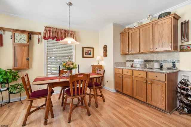 a view of dining room and kitchen with a table chairs a workspace