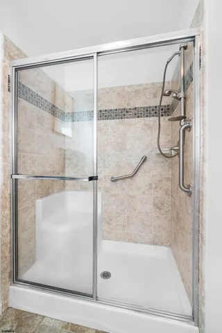 a bathroom with a glass shower door