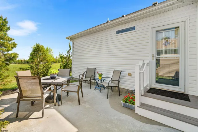 a view of a patio with table and chairs and potted plants
