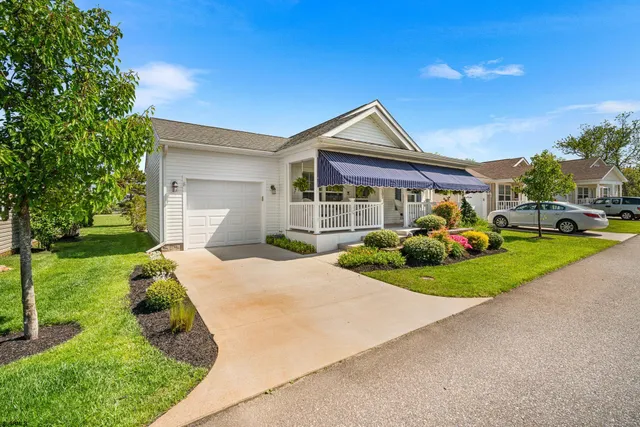 a front view of a house with a yard and porch