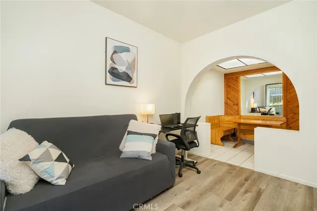 a living room with furniture and a mirror