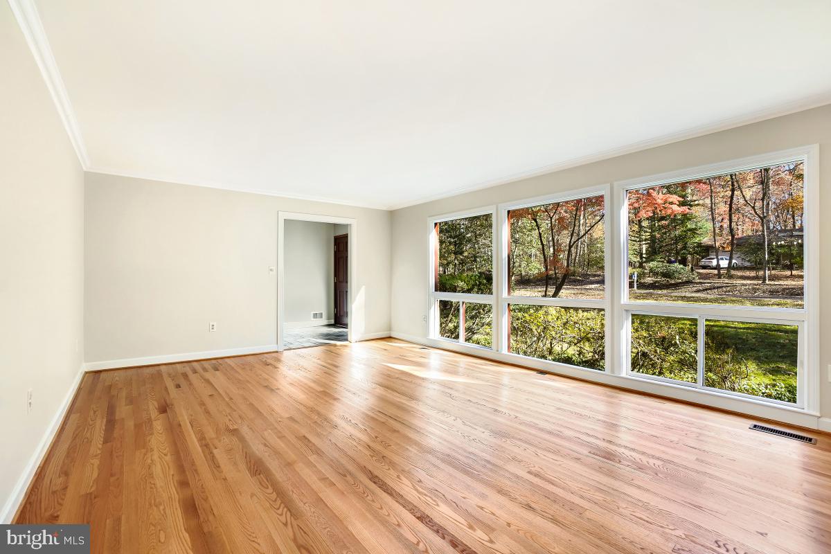 2606 Deerdell Lane Reston, VA 20191 - Photo 6 of 49 a view of an empty room with wooden floor and a window