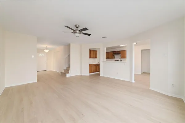 a view of a big room with windows and cabinet