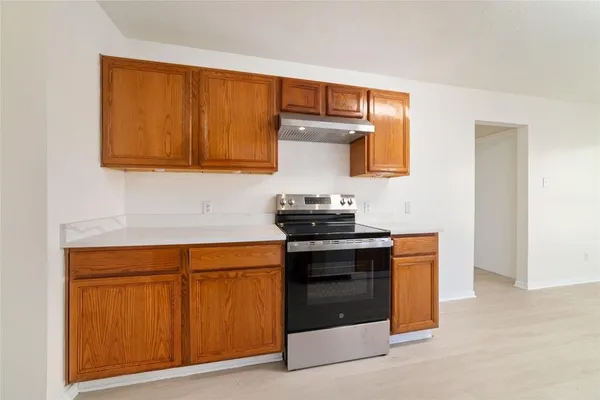 a kitchen with stainless steel appliances granite countertop a stove and a microwave
