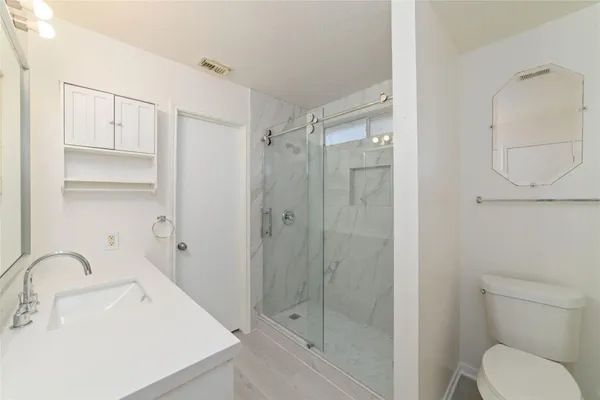 a bathroom with a sink toilet and shower