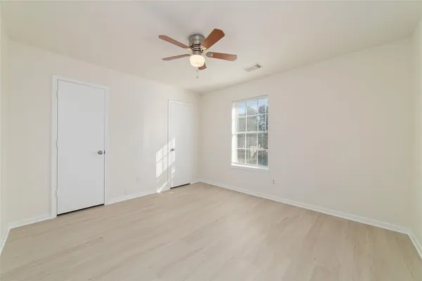 wooden floor in an empty room with a window