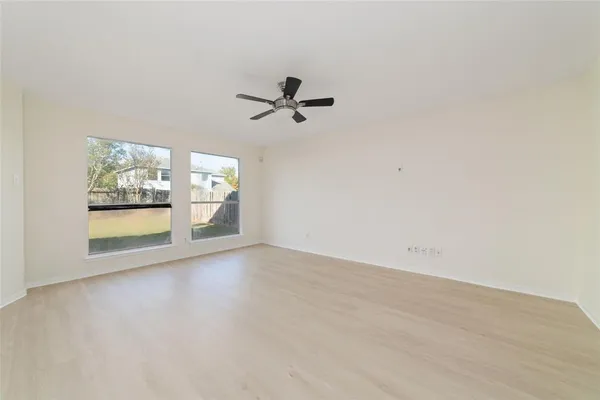 wooden floor in an empty room with a window