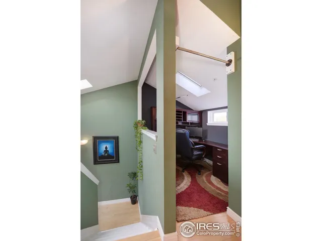a view of a living room with a bench and more cabinets