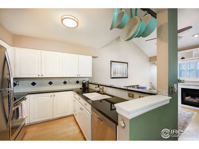 a kitchen with stainless steel appliances granite countertop a sink and a stove