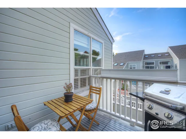 a view of a chairs and table in the balcony