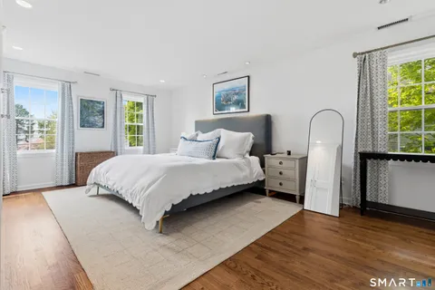 a spacious bedroom with a bed and a couch