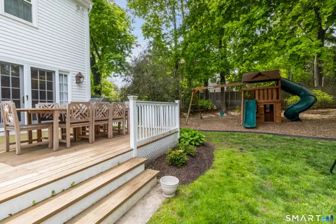 a view of a house with a yard and garden