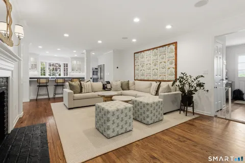 a living room with furniture fireplace and flat screen tv