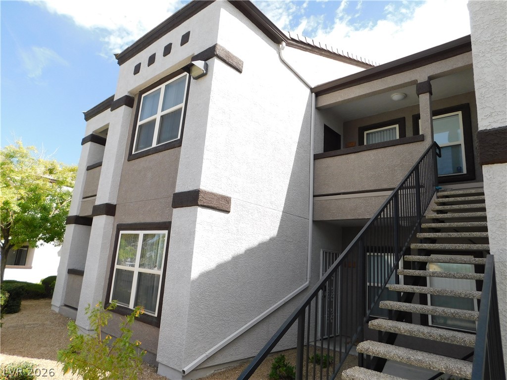 7255 West Sunset Road, Unit 2029 Las Vegas, NV 89113 - Photo 2 of 28 A well-maintained multi-story building features a durable stucco exterior and practical outdoor stair access.