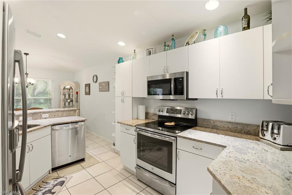 218 Marseille Drive Naples, FL 34112 - Photo 11 of 34 a kitchen with a sink a stove and cabinets