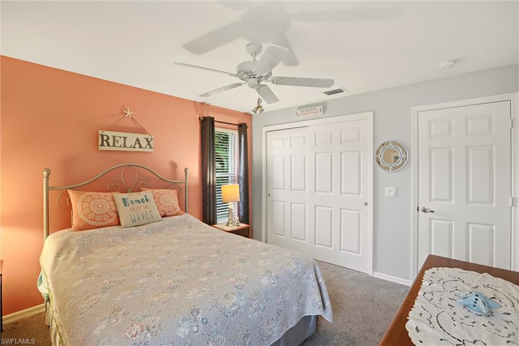 218 Marseille Drive Naples, FL 34112 - Photo 17 of 34 a bedroom with a bed and a chandelier