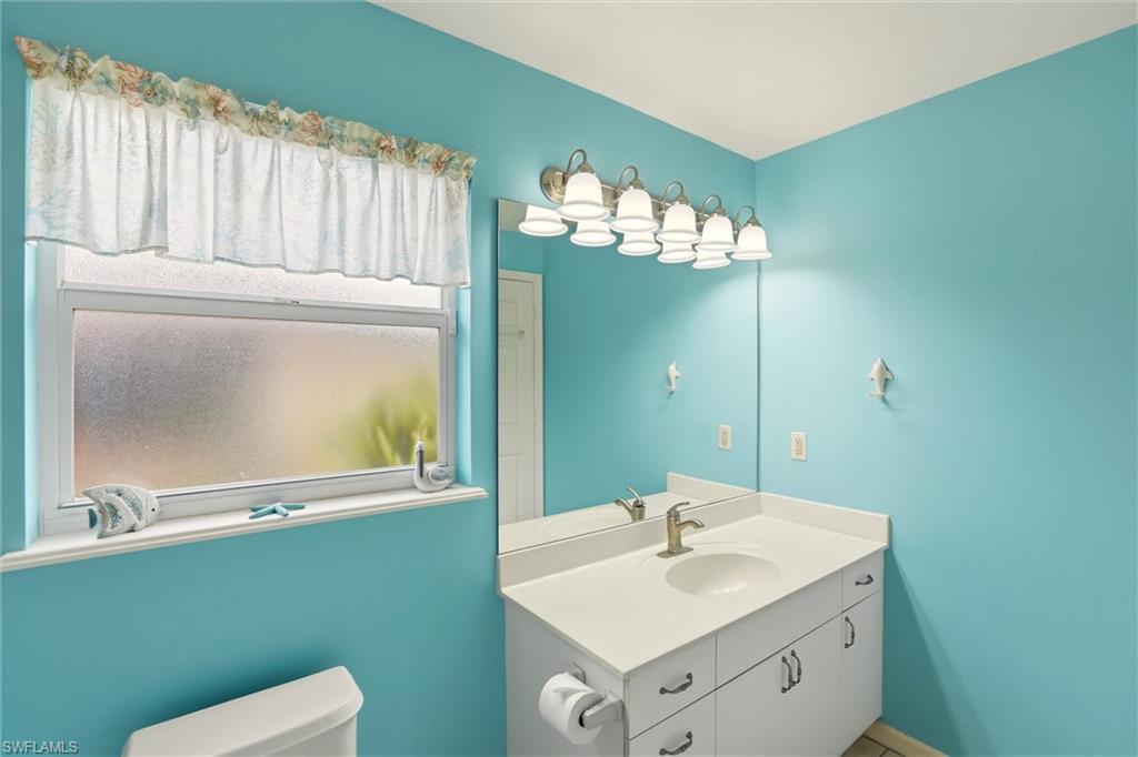 218 Marseille Drive Naples, FL 34112 - Photo 27 of 34 a bathroom with a sink and a mirror