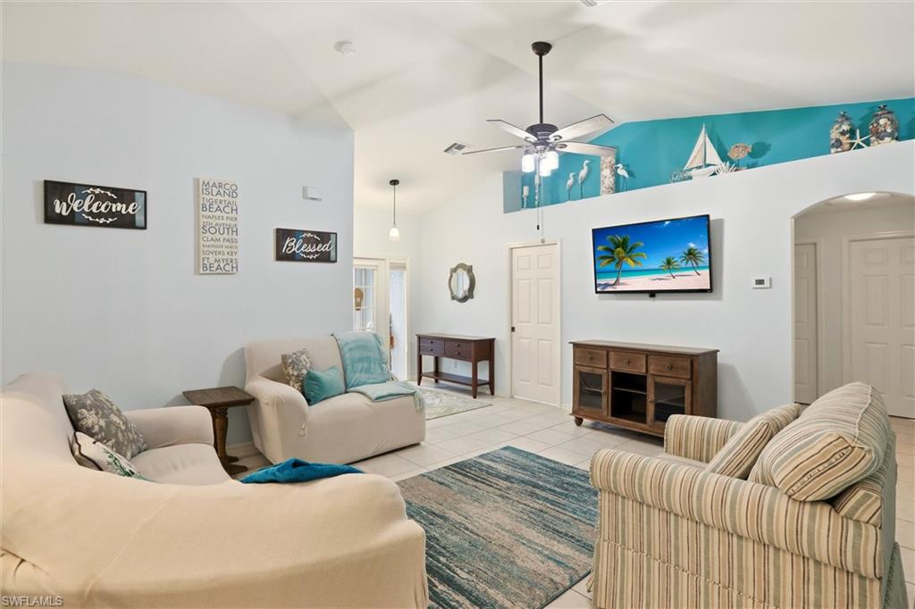 218 Marseille Drive Naples, FL 34112 - Photo 6 of 34 a living room with furniture a fireplace and a chandelier