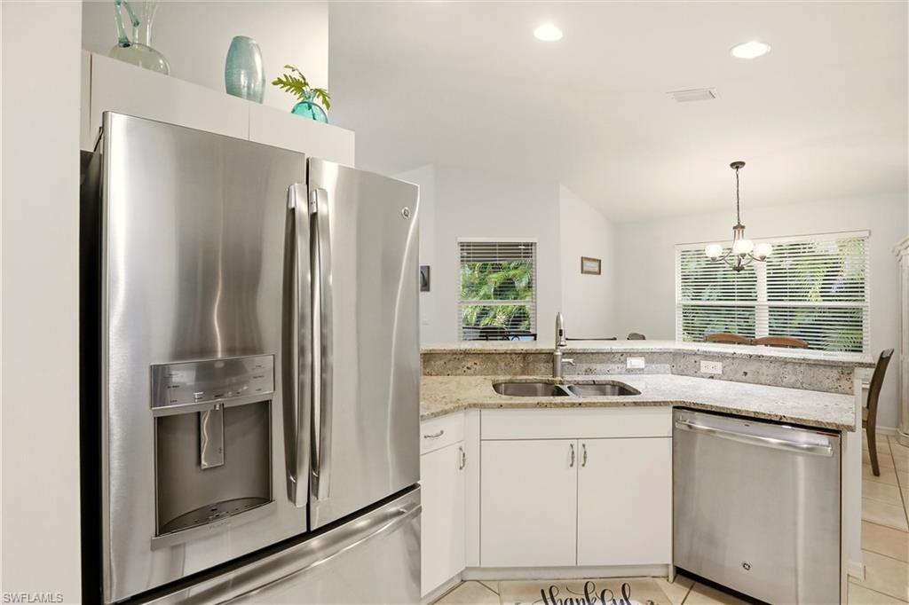 218 Marseille Drive Naples, FL 34112 - Photo 10 of 34 a kitchen with a sink and refrigerator